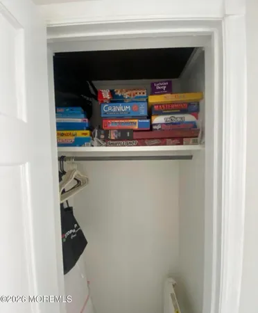 a room with a large mirror and a dresser