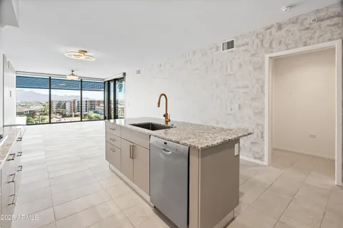 a kitchen with stainless steel appliances granite countertop a sink and cabinets