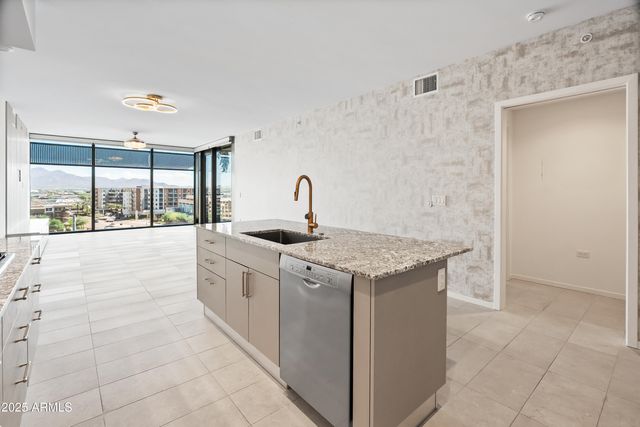 a kitchen with stainless steel appliances granite countertop a sink and cabinets