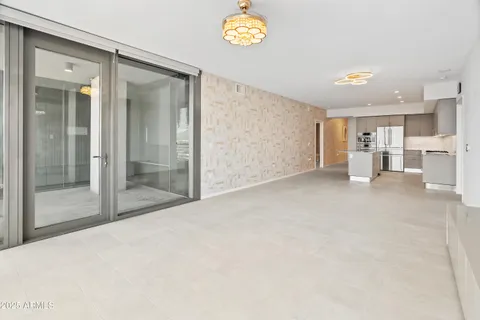 a view of a kitchen with refrigerator and window