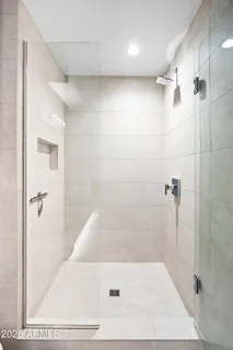 a bathroom with a granite countertop double vanity sink mirror and