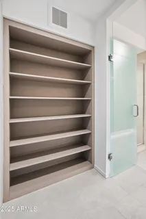 a view of walk in closet with clothes and shoes