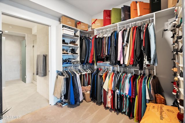 a view of walk in closet with empty racks