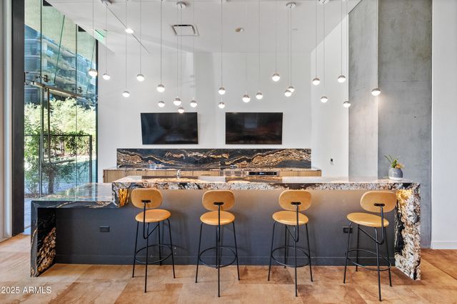 a outdoor space with furniture a flat screen tv and a fireplace