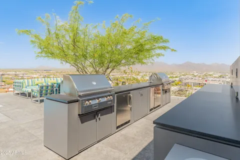 a kitchen with kitchen island granite countertop a sink and a stove top oven