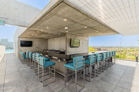 a view of a dining room with furniture and a flat screen tv