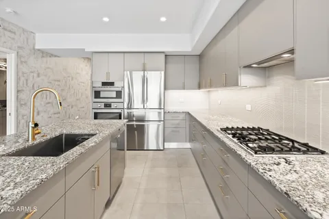 a kitchen with granite countertop a stove and a refrigerator