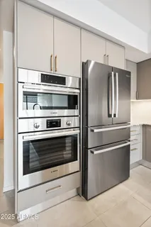 a kitchen with granite countertop stainless steel appliances and white cabinets