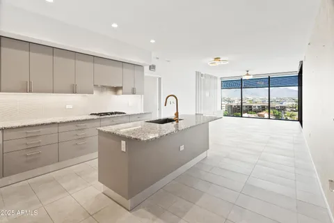 a kitchen with granite countertop cabinets and steel stainless steel appliances