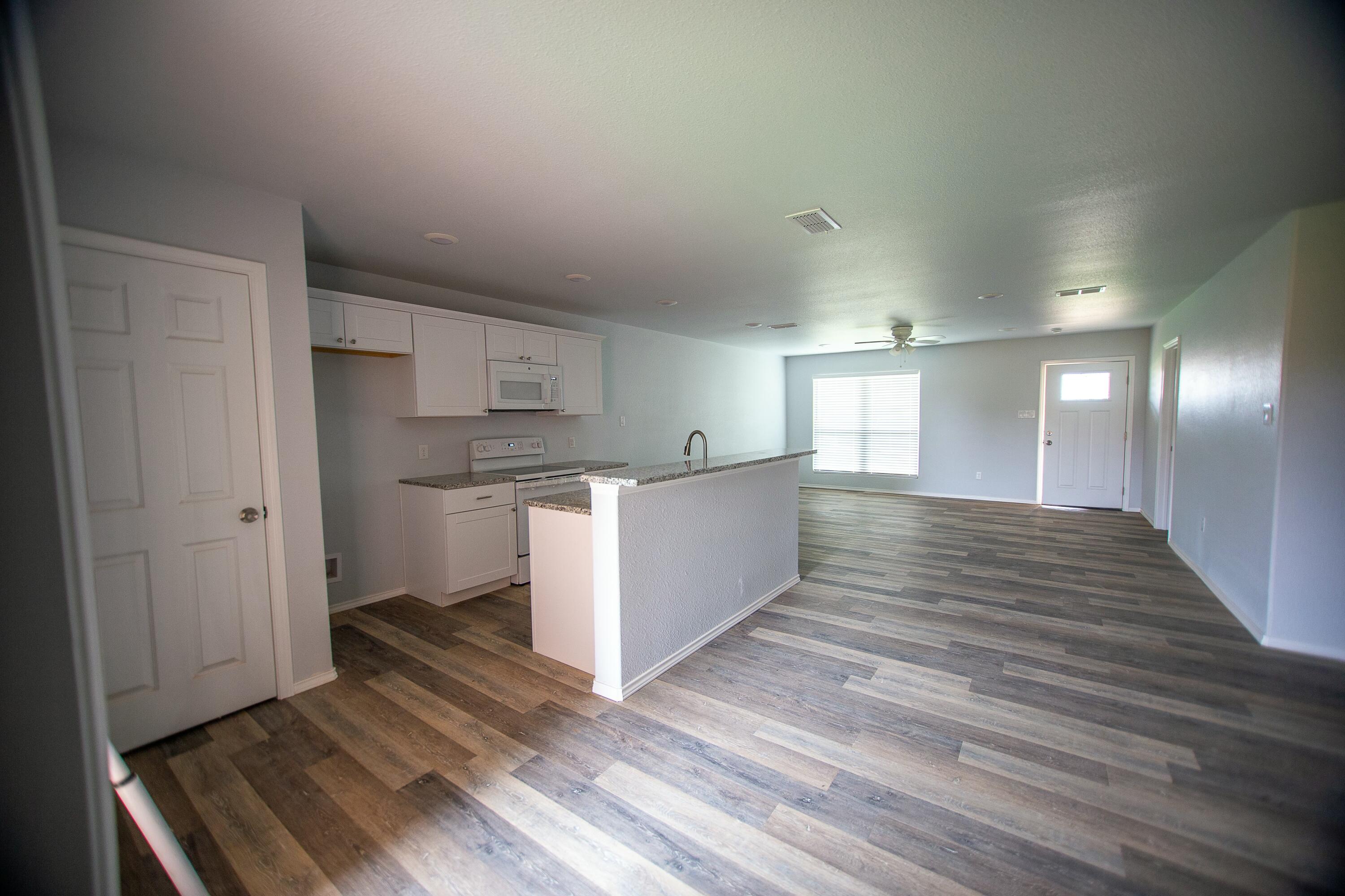 8613 10th Place Lubbock, TX 79416 - Photo 7 of 9 a view of kitchen and wooden floor