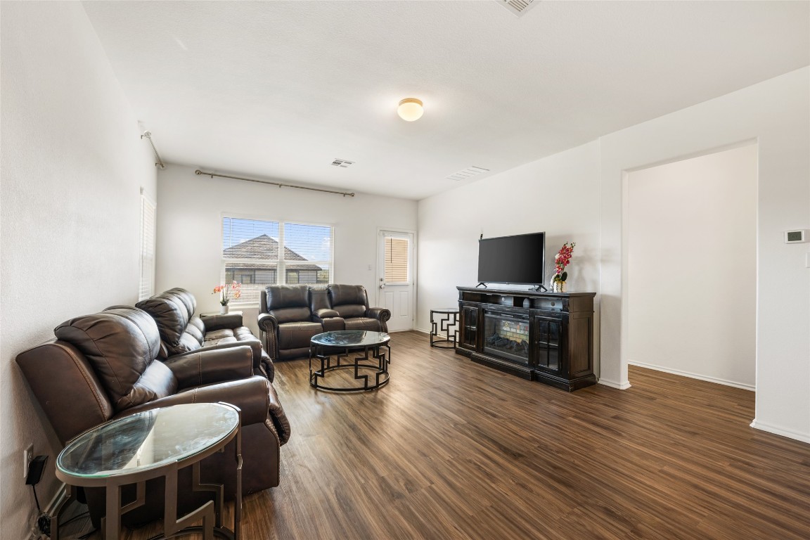 132 Joe Kidd Lane, Unit 132 Jarrell, TX 76537 - Photo 12 of 40 a living room with furniture and a flat screen tv