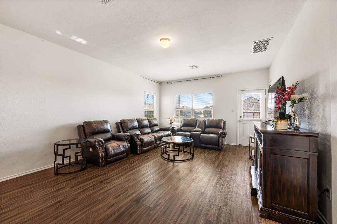 132 Joe Kidd Lane, Unit 132 Jarrell, TX 76537 - Photo 14 of 40 a living room with furniture and wooden floor
