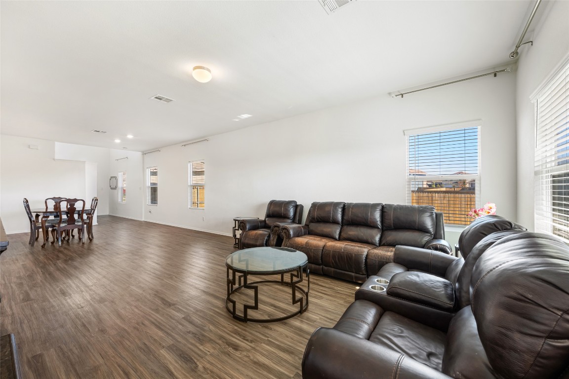 132 Joe Kidd Lane, Unit 132 Jarrell, TX 76537 - Photo 15 of 40 a living room with furniture and a wooden floor