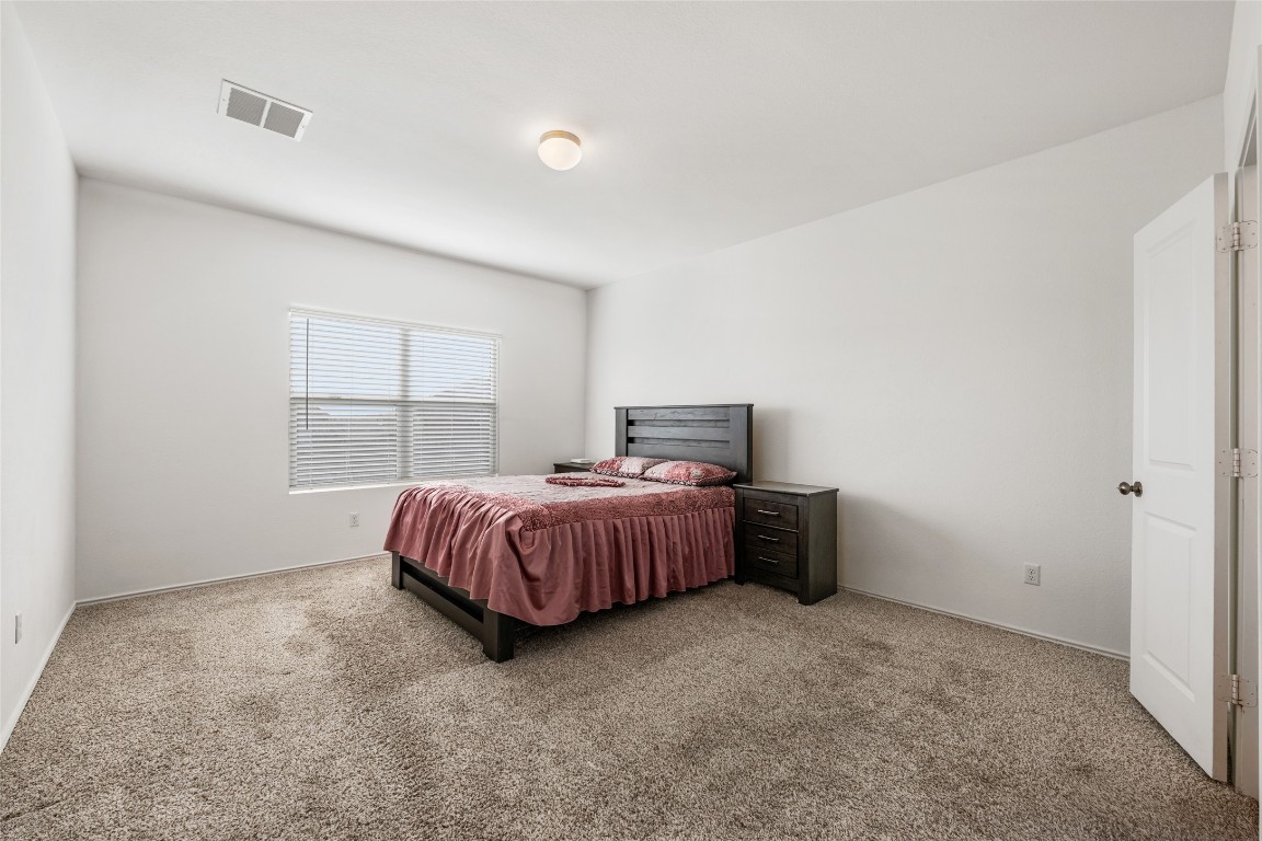 132 Joe Kidd Lane, Unit 132 Jarrell, TX 76537 - Photo 16 of 40 a room with a bed and window