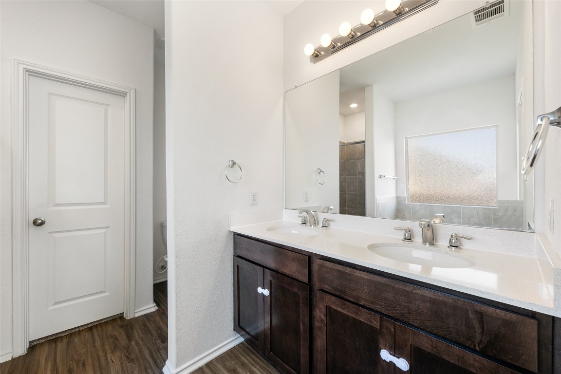 132 Joe Kidd Lane, Unit 132 Jarrell, TX 76537 - Photo 20 of 40 a bathroom with a double vanity sink and mirror