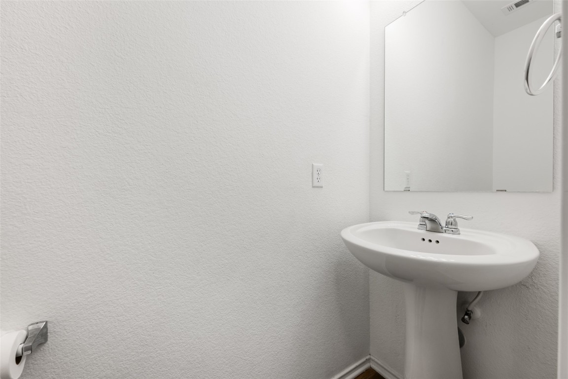 132 Joe Kidd Lane, Unit 132 Jarrell, TX 76537 - Photo 24 of 40 a bathroom with a sink a mirror and a toilet