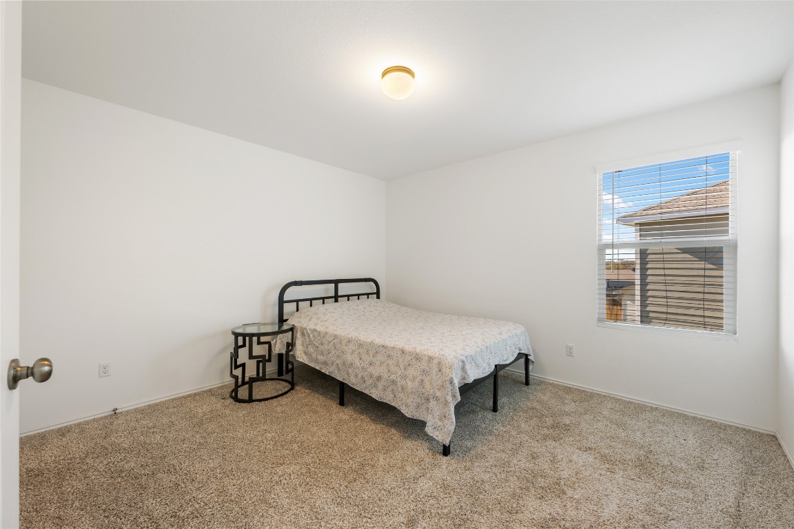 132 Joe Kidd Lane, Unit 132 Jarrell, TX 76537 - Photo 33 of 40 a room with a bed and a table