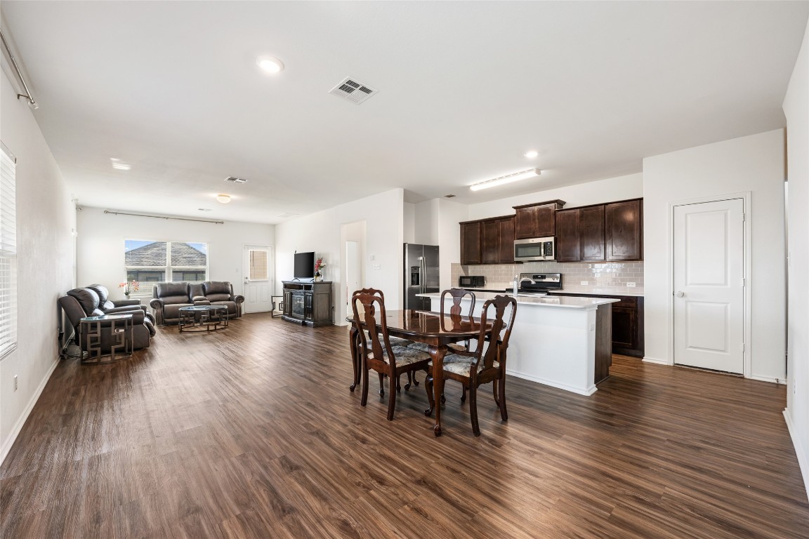 132 Joe Kidd Lane, Unit 132 Jarrell, TX 76537 - Photo 7 of 40 a living room with furniture dining table and wooden floor