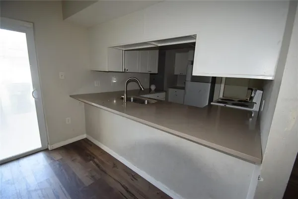 a kitchen with a sink stainless steel appliances and cabinets