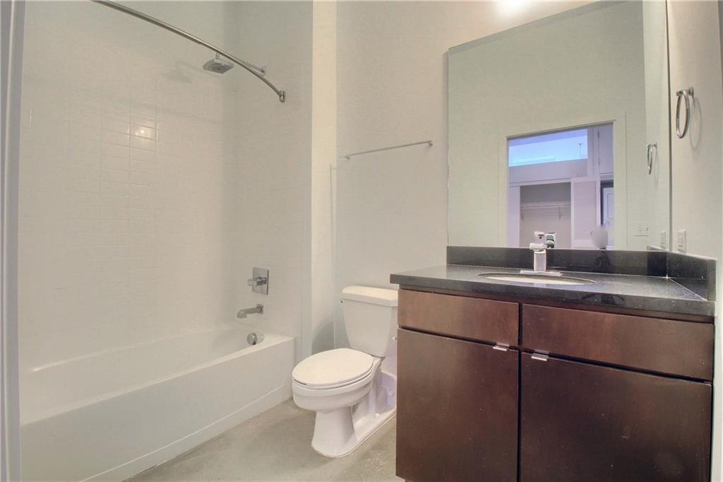 507 Sabine Street, Unit 602 Austin, TX 78701 - Photo 14 of 22 a bathroom with a sink a toilet and shower