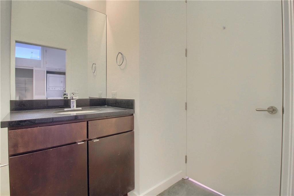 507 Sabine Street, Unit 602 Austin, TX 78701 - Photo 15 of 22 a bathroom with a sink and mirror