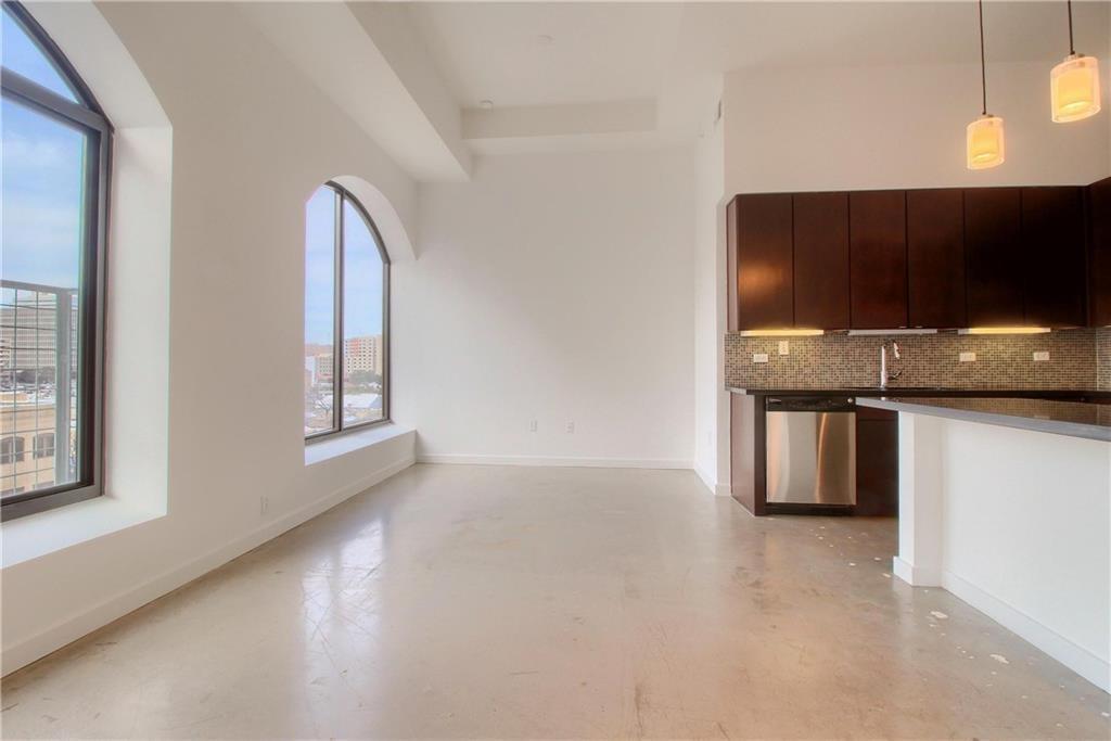 507 Sabine Street, Unit 602 Austin, TX 78701 - Photo 7 of 22 a kitchen with stainless steel appliances a microwave and a sink