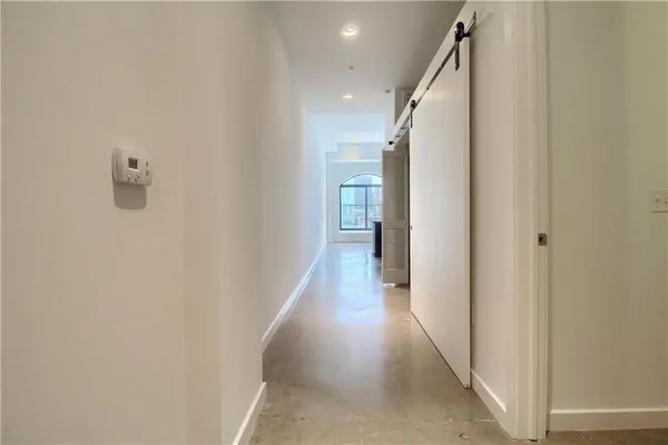 a view of a hallway with wooden floor