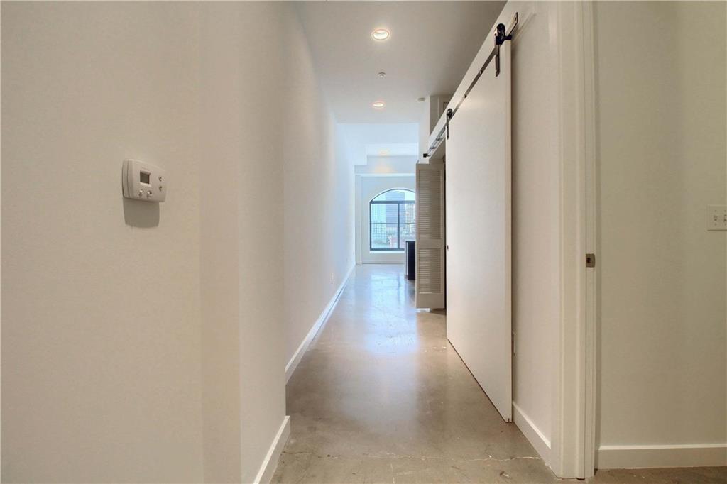 507 Sabine Street, Unit 602 Austin, TX 78701 - Photo 8 of 22 a view of a hallway with wooden floor