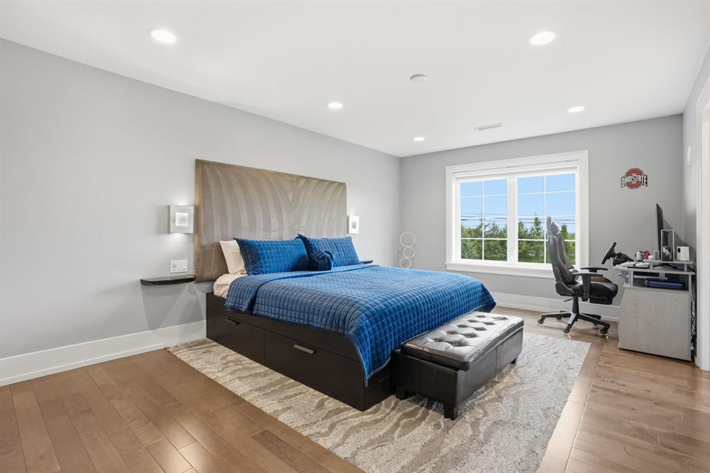 931 Pleasant Hill Road Wexford, PA 15090 - Photo 34 of 50 a spacious bedroom with a bed and wooden floor