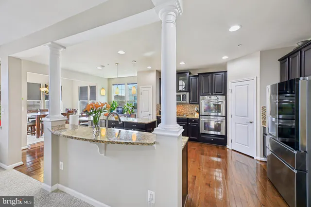 a kitchen with a refrigerator and a stove top oven