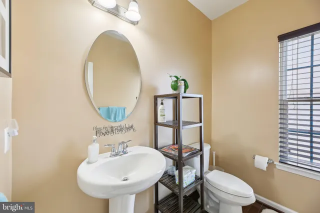 a dining hall with stainless steel appliances granite countertop a refrigerator and a living room view