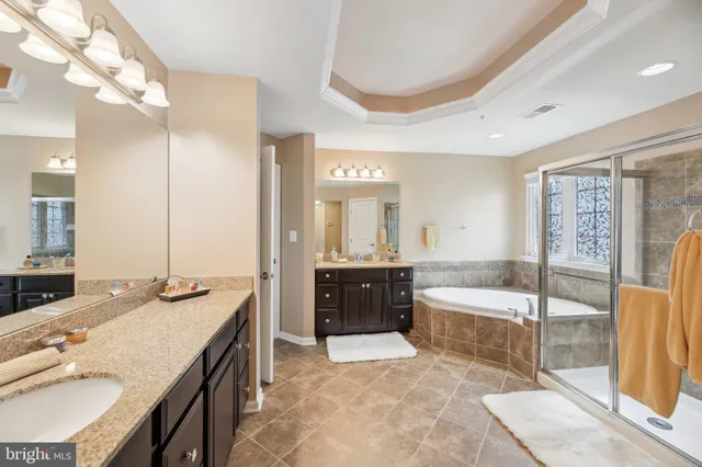 a spacious bathroom with a granite countertop tub shower and sink
