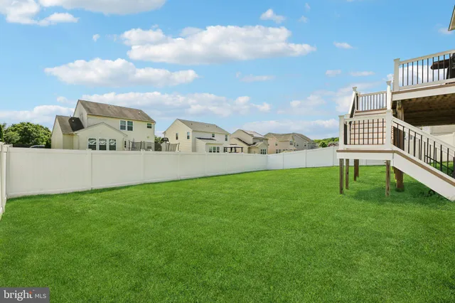 a view of a patio with couches table and chairs and potted plants