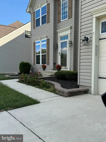 a view of a house with backyard sitting area and garden
