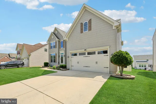 a view of a white house with a yard