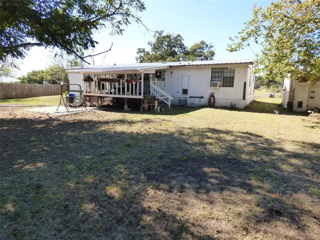 a view of a house with a yard covered with snow in front of house