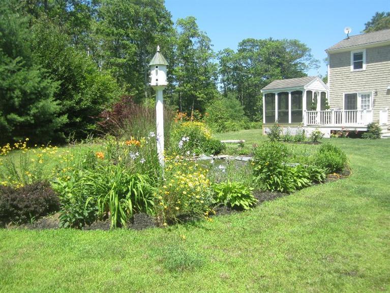 5 Cotuit Road Sandwich, MA 02563 - Photo 33 of 34 a view of a house with a backyard and garden