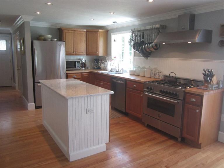 5 Cotuit Road Sandwich, MA 02563 - Photo 7 of 34 a kitchen with stainless steel appliances granite countertop a sink stove and refrigerator