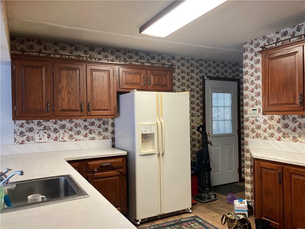 115 Wayne Prospect, PA 16052 - Photo 3 of 21 a kitchen with a refrigerator and a stove top oven