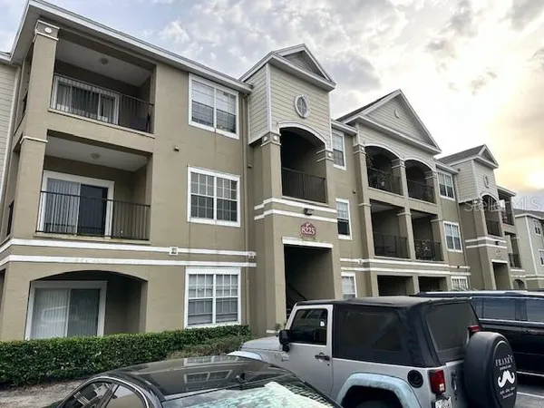 a front view of a residential apartment building with a yard