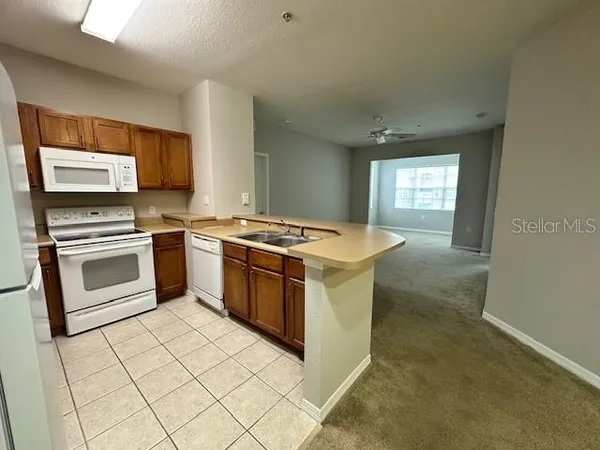 a kitchen with a stove top oven and cabinets