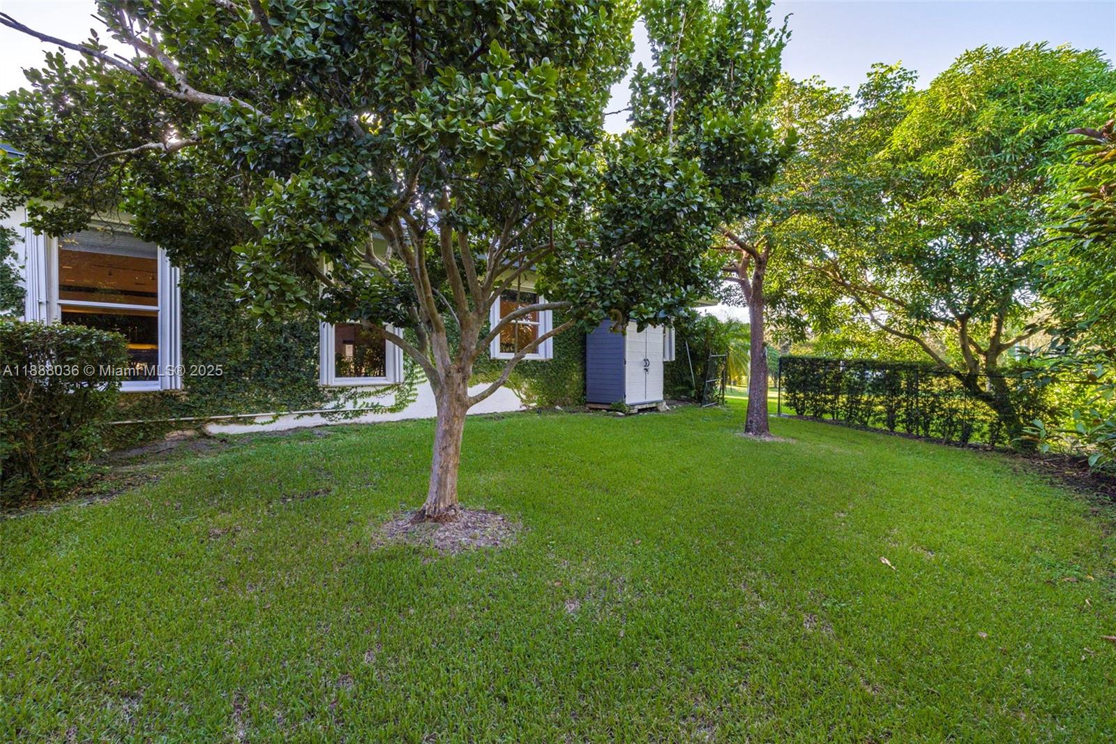 12555 Southwest 34th Place Davie, FL 33330 - Photo 16 of 73 a house with green field in front of it