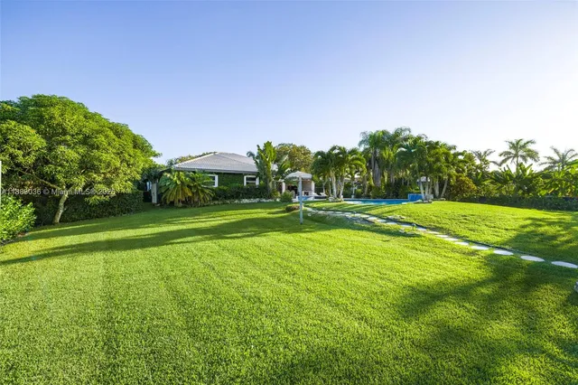 a view of a park with trees and a sign