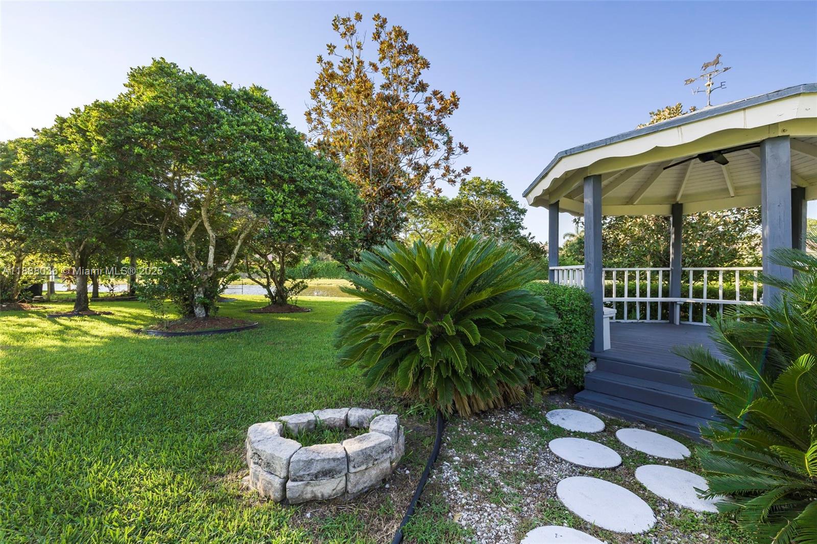 12555 Southwest 34th Place Davie, FL 33330 - Photo 37 of 73 a view of a porch with chairs and potted plants