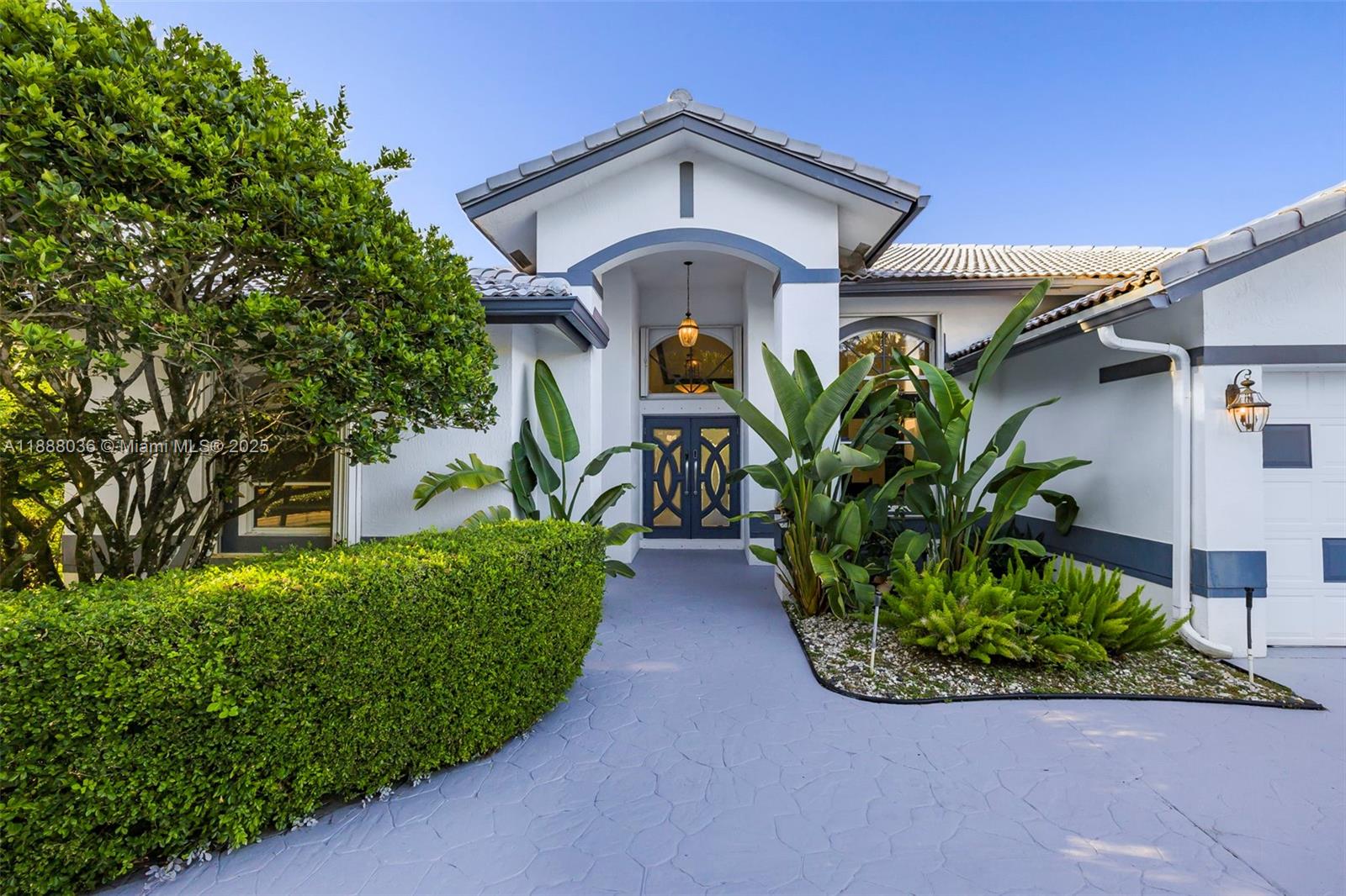 12555 Southwest 34th Place Davie, FL 33330 - Photo 4 of 73 a view of a house with potted plants and large trees