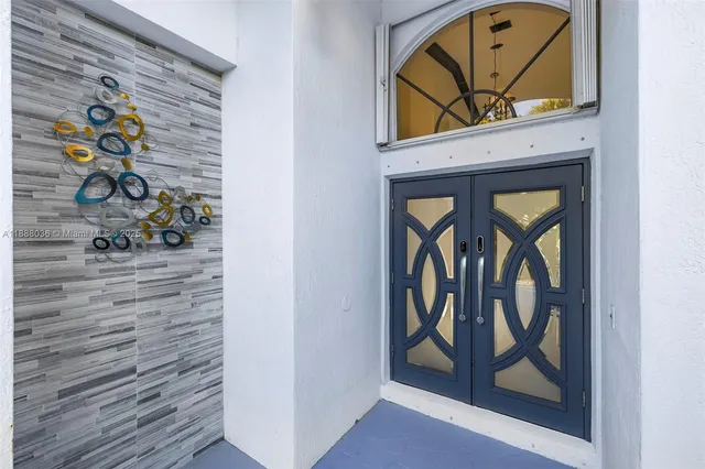 a room with pool table and a wooden floor