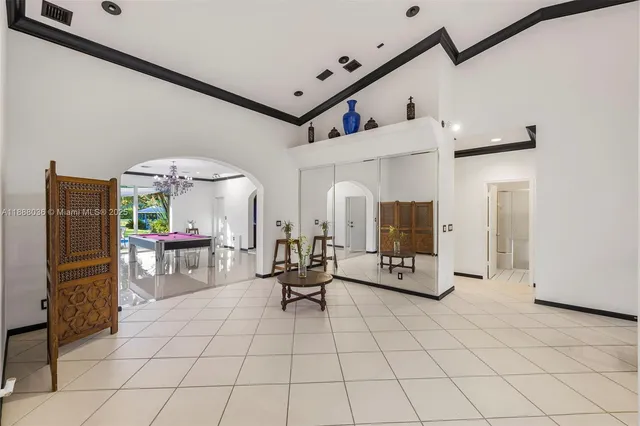 a spacious bedroom with a bed and a wooden floor