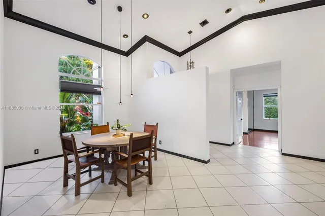 a spacious bathroom with a granite countertop sink a mirror and a bathtub