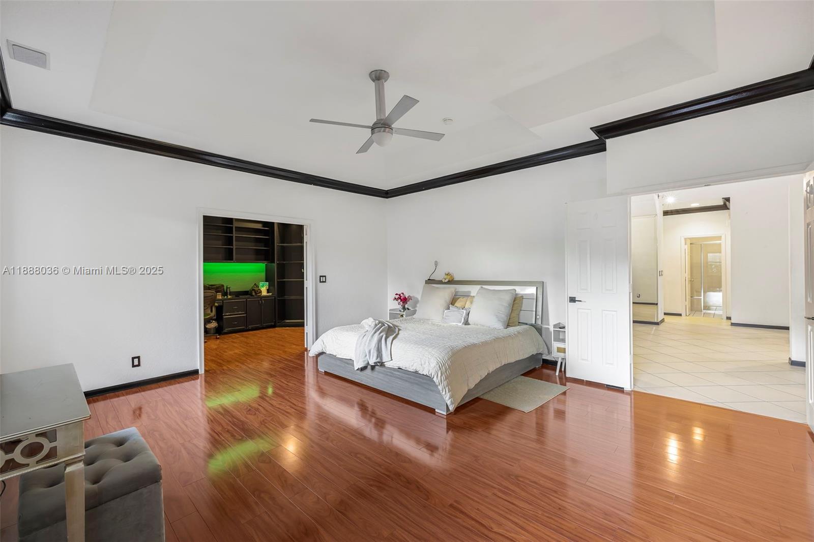 12555 Southwest 34th Place Davie, FL 33330 - Photo 66 of 73 a spacious bedroom with a bed and a wooden floor