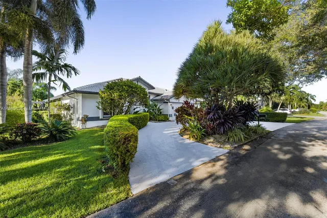 a view of backyard of house with green space